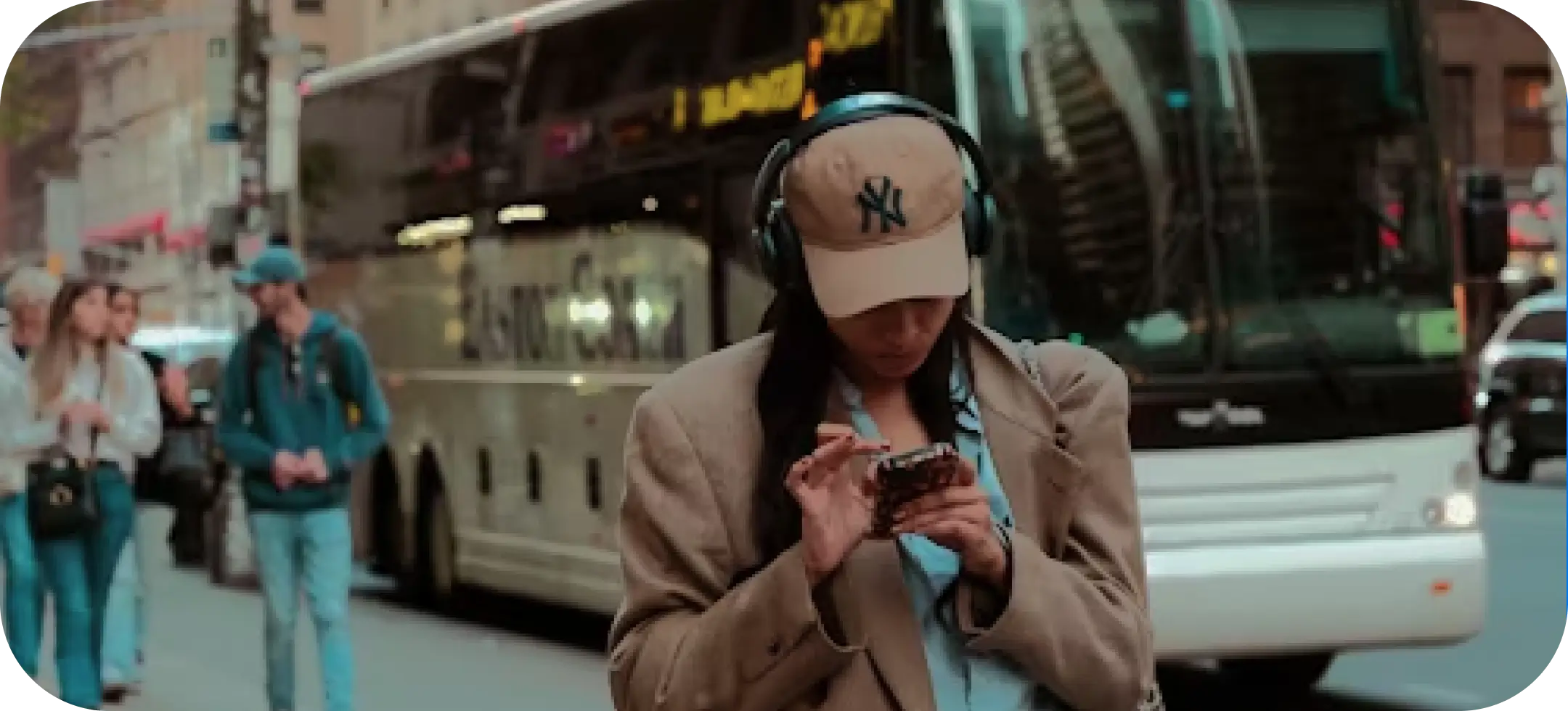 A woman standing in the city using her cellphone. Photo by Nellie Adamyan