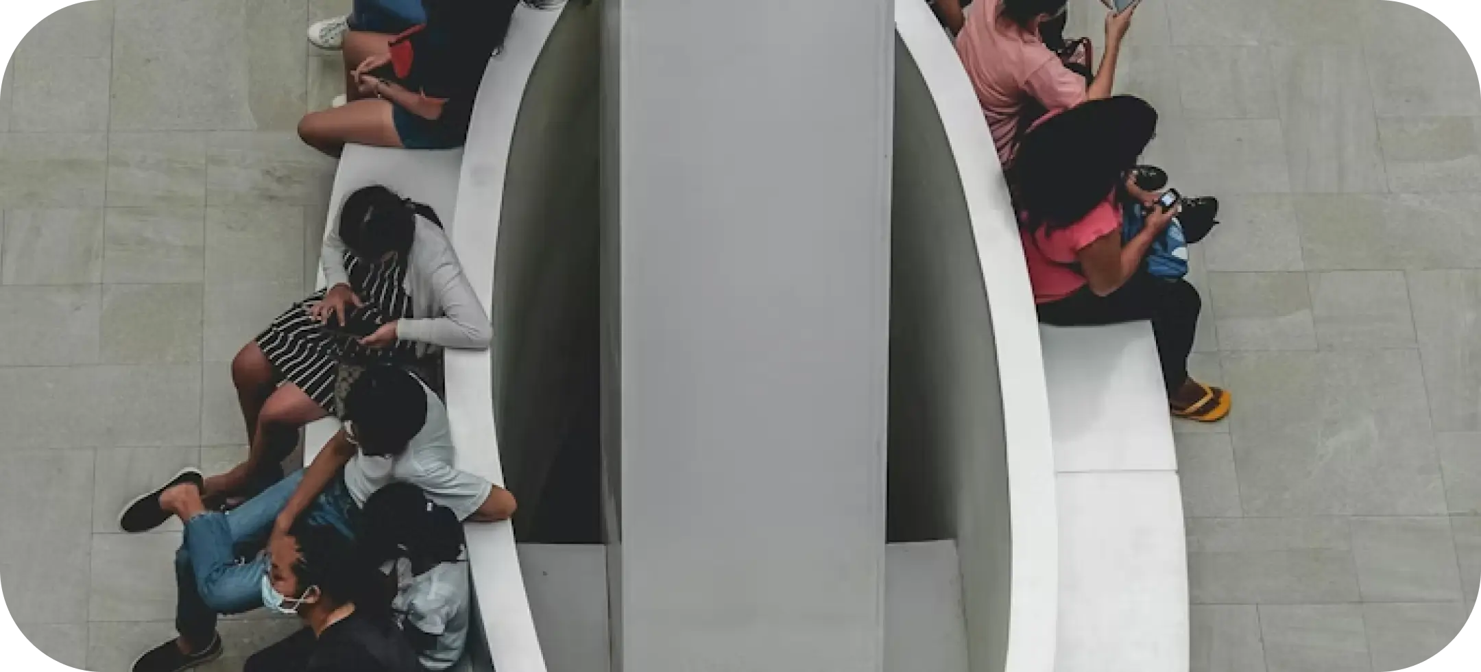 A group of people sitting in a public space. Photo by Eryka Rose Raton